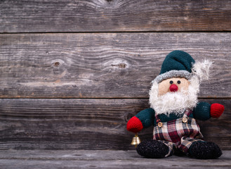 Obraz na płótnie Canvas Santa Claus toy against wooden background - Christmas concept