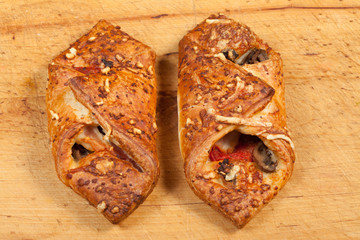 Small pizza on a wooden board.