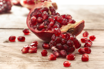 Fresh and juicy pomegranate fruit on wood