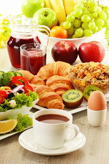 Breakfast with coffee, juice, croissant, salad, musli and egg