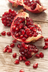 Fresh and juicy pomegranate fruit on wood