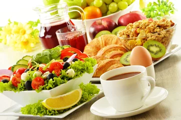 Foto op Canvas Breakfast with coffee, juice, croissant, salad, musli and egg © monticellllo