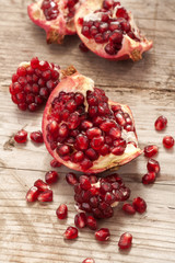 Fresh and juicy pomegranate fruit on wood