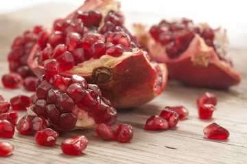 Fresh and juicy pomegranate fruit on wood
