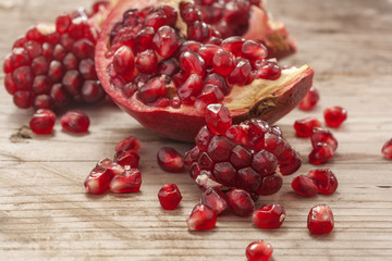 Fresh and juicy pomegranate fruit on wood