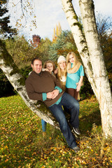 Happy Family Resting Outdoors during a nice day in fall season