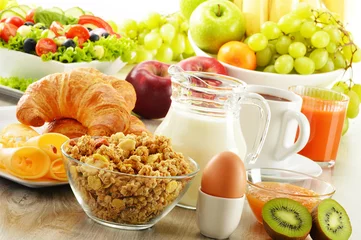 Fotobehang Breakfast with coffee, juice, croissant, salad, muesli and egg © monticellllo