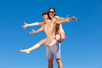 Happy Young Couple Together On The Beach