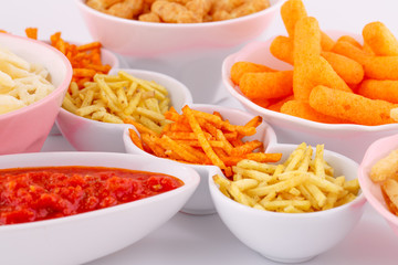 Potato, corn and wheat chips in bowls