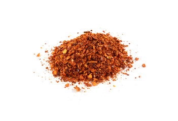 Dried red peppers and flakes, isolated on white.
