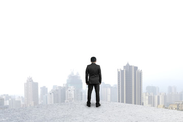 Fototapeta premium businessman standing on concrete floor gazing at city