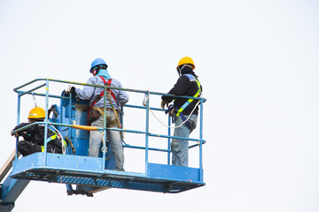workers on lifts