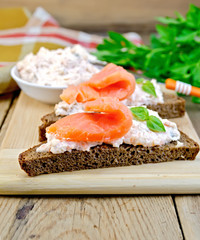 Sandwiches on bread with salmon on board