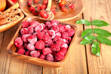 frozen raspberries in the wooden bowl with spoon...