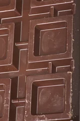 Foto auf Acrylglas Closeup detail of chocolate parts on white background. © Orlando Bellini