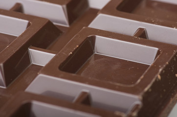 Closeup detail of chocolate parts on white background.