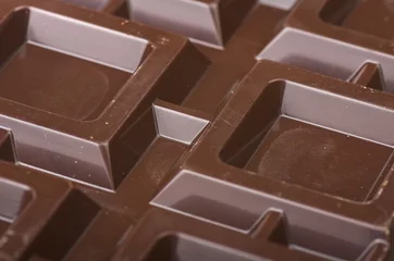 Rollo Closeup detail of chocolate parts on white background. © Orlando Bellini