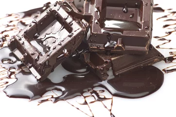 Foto auf Leinwand Closeup detail of chocolate parts on white background. © Orlando Bellini