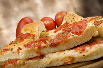 Focaccia with tomatoes and oregano close up