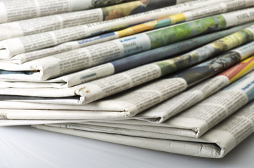 Pile of Various newspapers over white background. - 58439349