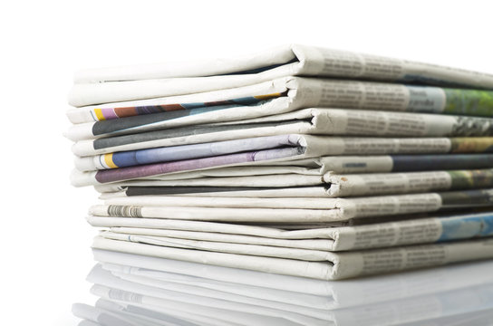Pile of Various newspapers over white background.