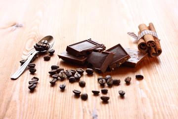 chocolate, cinamon and coffee beans on wooden table