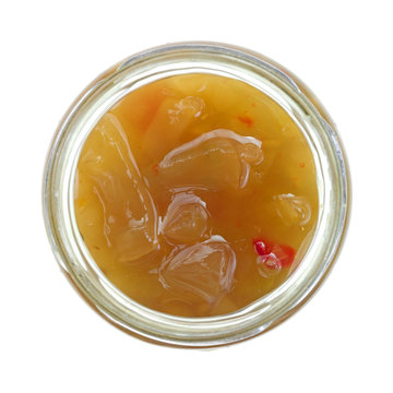 Green tomato piccalilli in an open jar