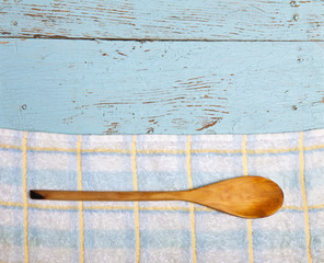 wooden spoon on top of the towels on the table