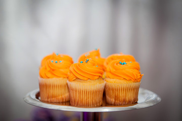 Creamy orange cupcakes on a platter