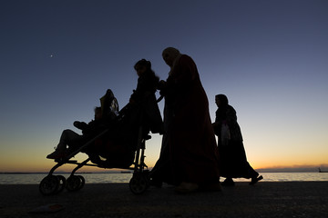 Silouetes of people walking on the sunset
