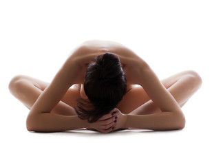 Fototapeta premium Close-up of slim naked girl meditates in studio