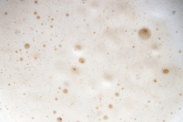 Creamy foam in the coffee as a background