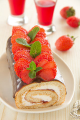 Chocolate swiss roll cake with strawberries