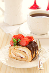 Chocolate swiss roll cake with strawberries