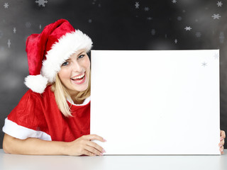 Woman shows black board for christmas