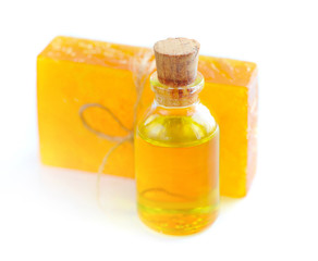 Essential oil with a floral handmade soap on white background
