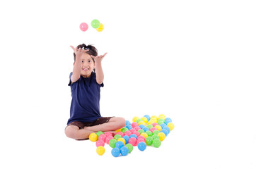 Fototapeta premium Happy little girl playing with colourful balls