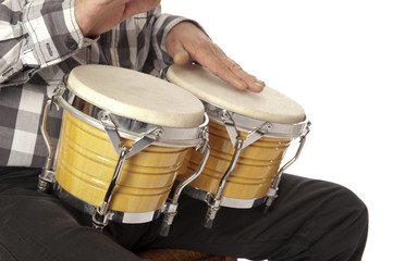 Man playing bongo on his lap - 58451199