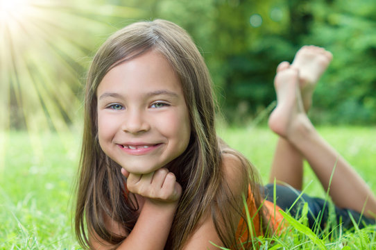 Funny Girl lying on sunny Gras