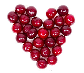 A lot of ripe cherries heart shaped