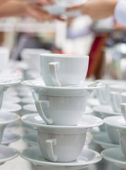 Lots of coffee cups with hands on background