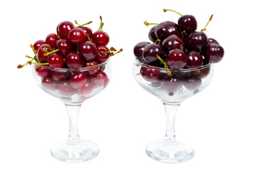 Two transparent glass bowl of ripe cherries