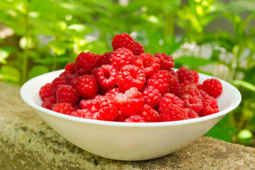 A plate with berries ripe raspberry