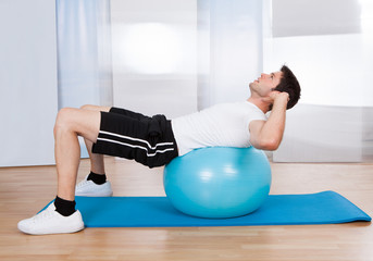 Man Doing Sit Ups On Fitness Ball