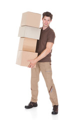 Man Carrying Stack Of Boxes