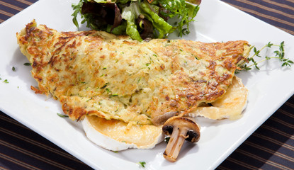 Potato pancake filled by camembert and mushrooms