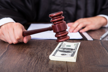Judge Hitting Mallet On Dollar