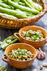 Closeup of broad beans served with parsley