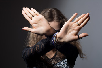 Out of focus woman with her hands signaling to stop isolated