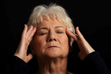 An old lady having a headache.
